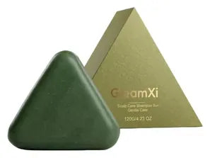 Green triangle shampoo bar beside its triangular gold-green box